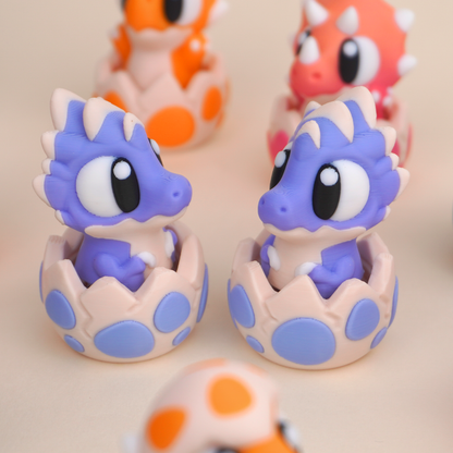 Baby Dinosaur Clicker Toy, purple dinosaur character in its eggshell, close-up pair view
